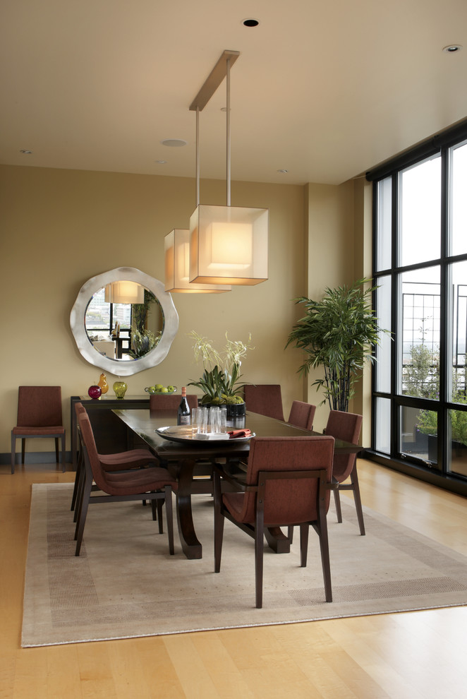 Dining room - modern light wood floor dining room idea in Portland with beige walls