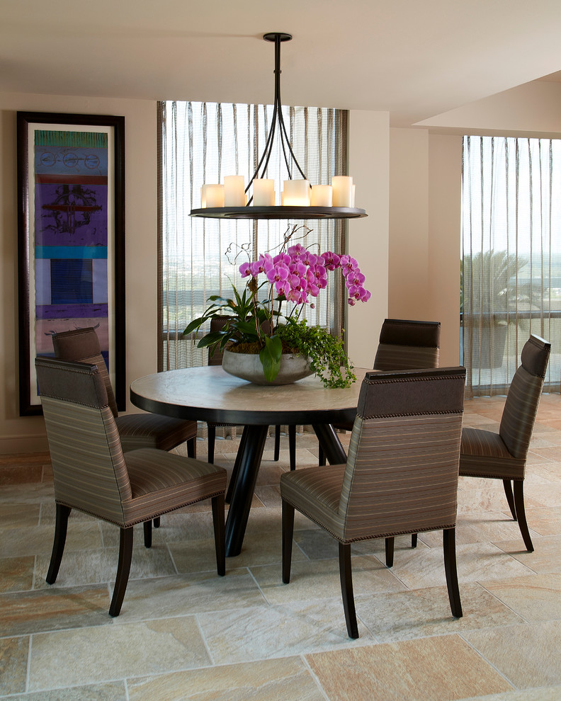 Immagine di una piccola sala da pranzo aperta verso il soggiorno con pareti beige e pavimento in ardesia