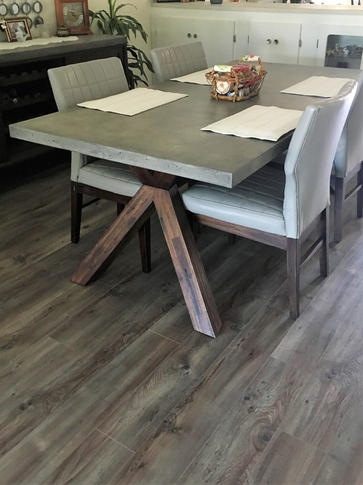 Photo of a medium sized contemporary open plan dining room in Tampa with white walls, medium hardwood flooring, beige floors and no fireplace.