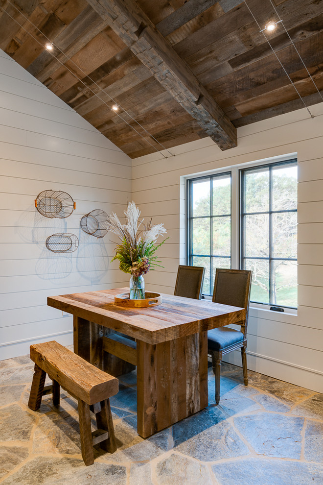 Example of a small mountain style slate floor great room design in Other with white walls and no fireplace