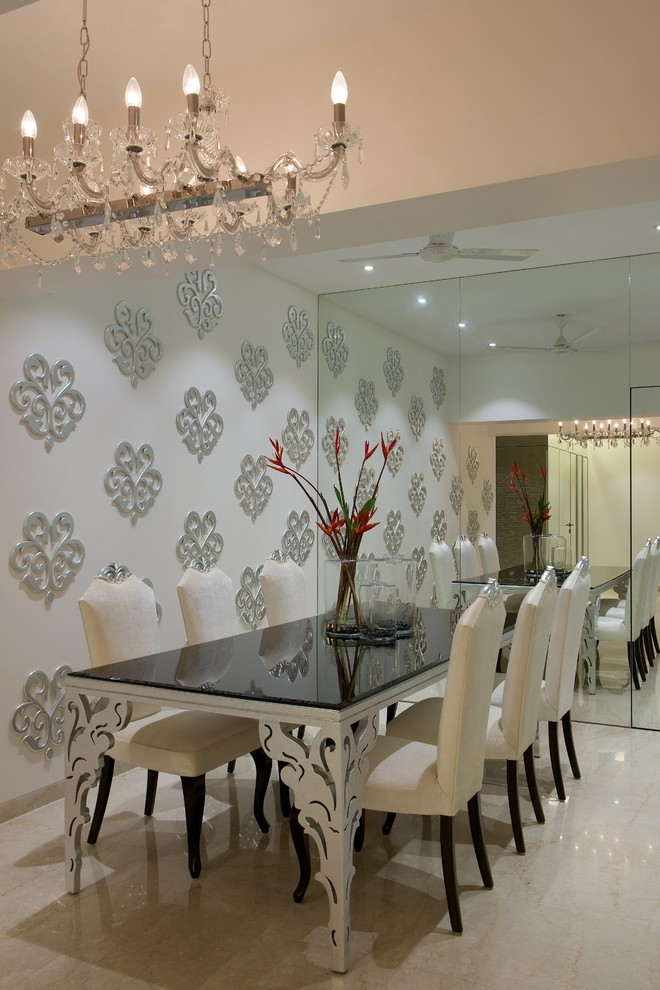 Inspiration for a large contemporary enclosed dining room in Mumbai with marble flooring.