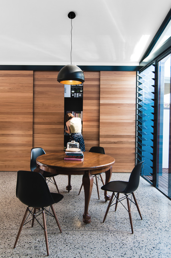 This is an example of a small contemporary kitchen/dining room in Melbourne with concrete flooring.