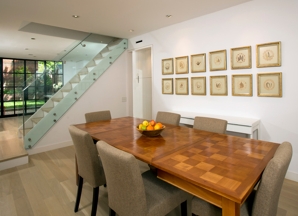 This is an example of a contemporary dining room in DC Metro with white walls.