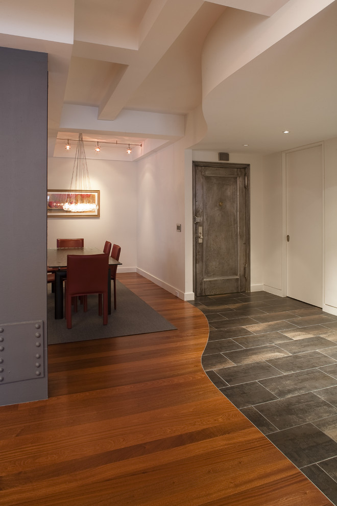 Trendy dark wood floor dining room photo in New York with white walls
