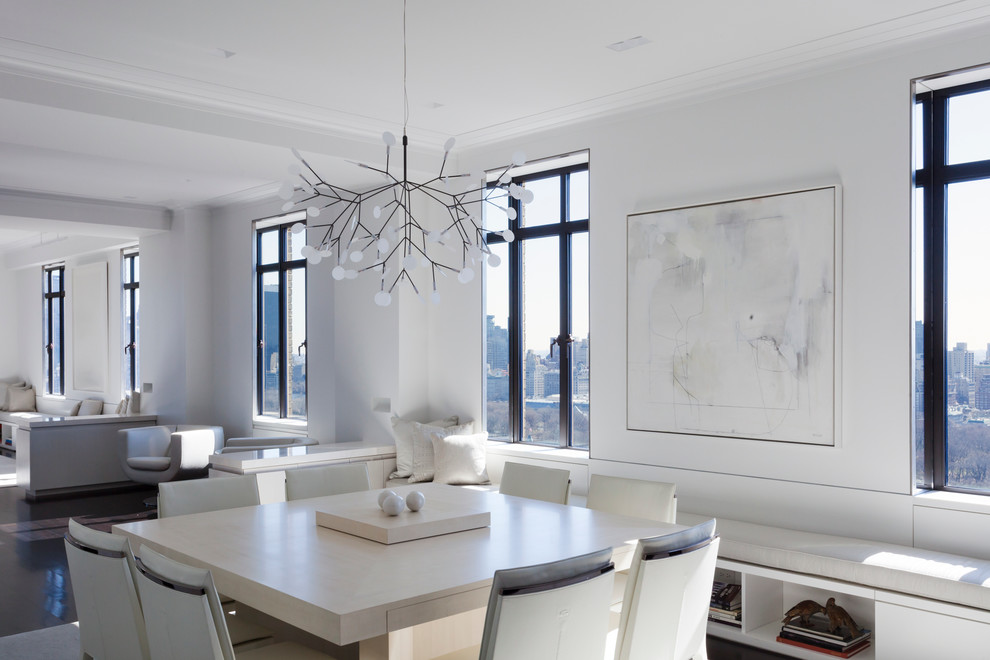 This is an example of a contemporary open plan dining room in New York with white walls and dark hardwood flooring.