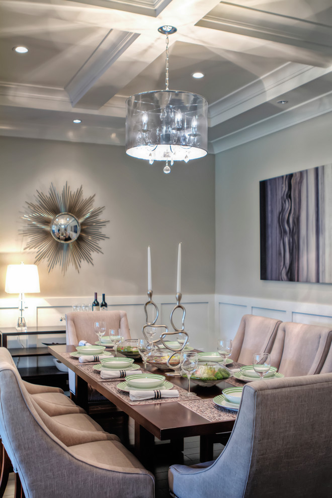 Contemporary dining room in Vancouver with grey walls and feature lighting.