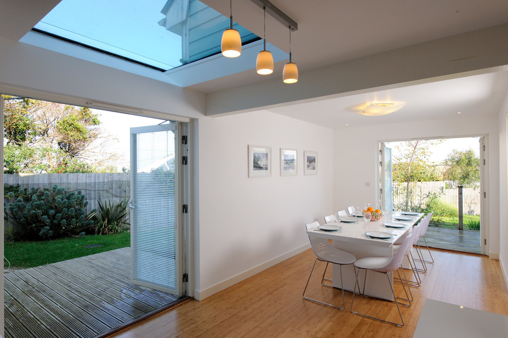 This is an example of a contemporary dining room in Cornwall.