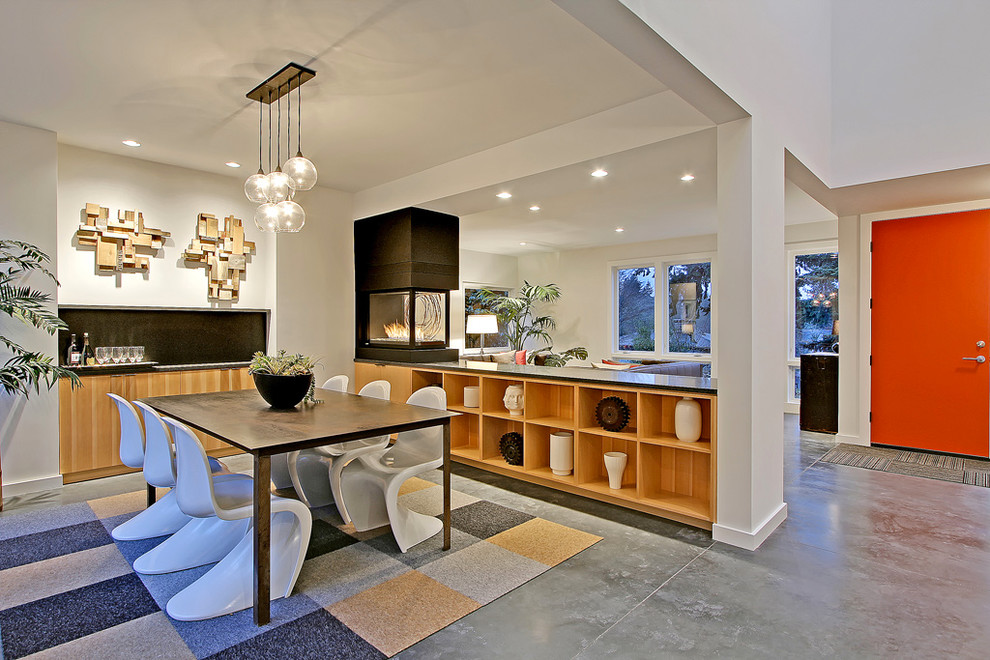 This is an example of a contemporary dining room in Other with concrete flooring.