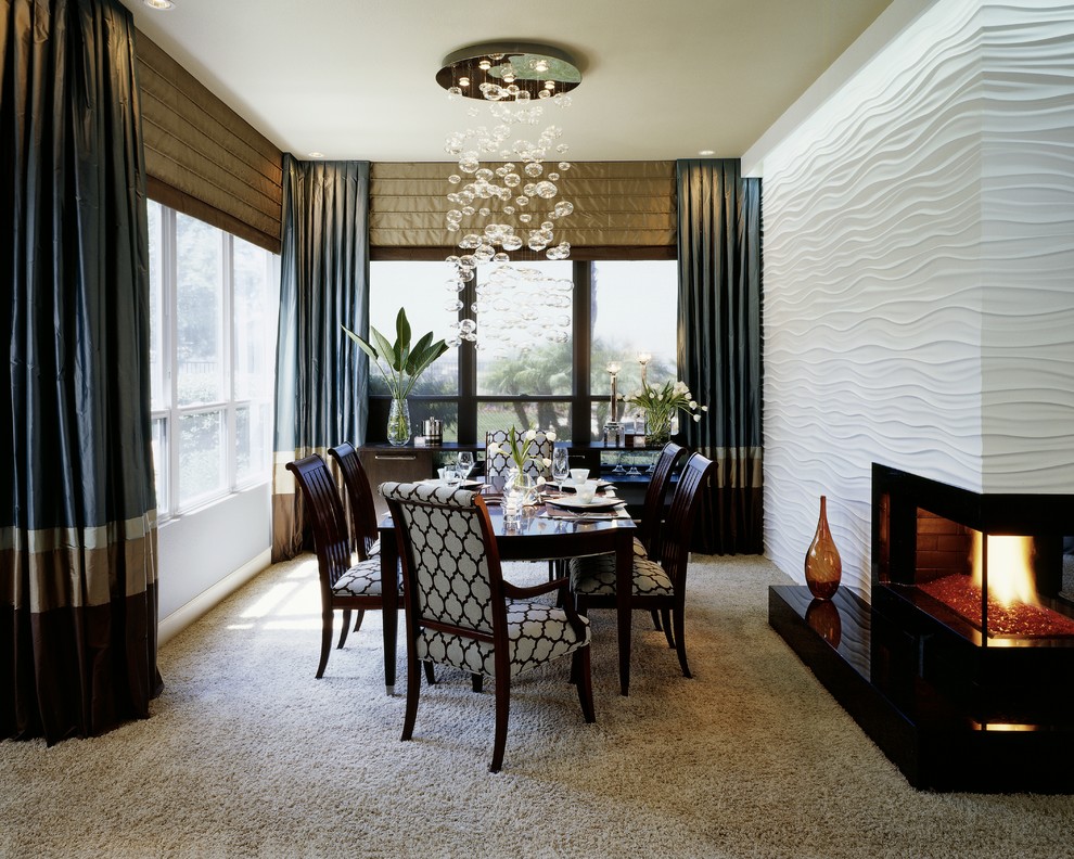Immagine di una sala da pranzo aperta verso la cucina minimal di medie dimensioni con moquette, camino classico, pareti bianche e cornice del camino in metallo