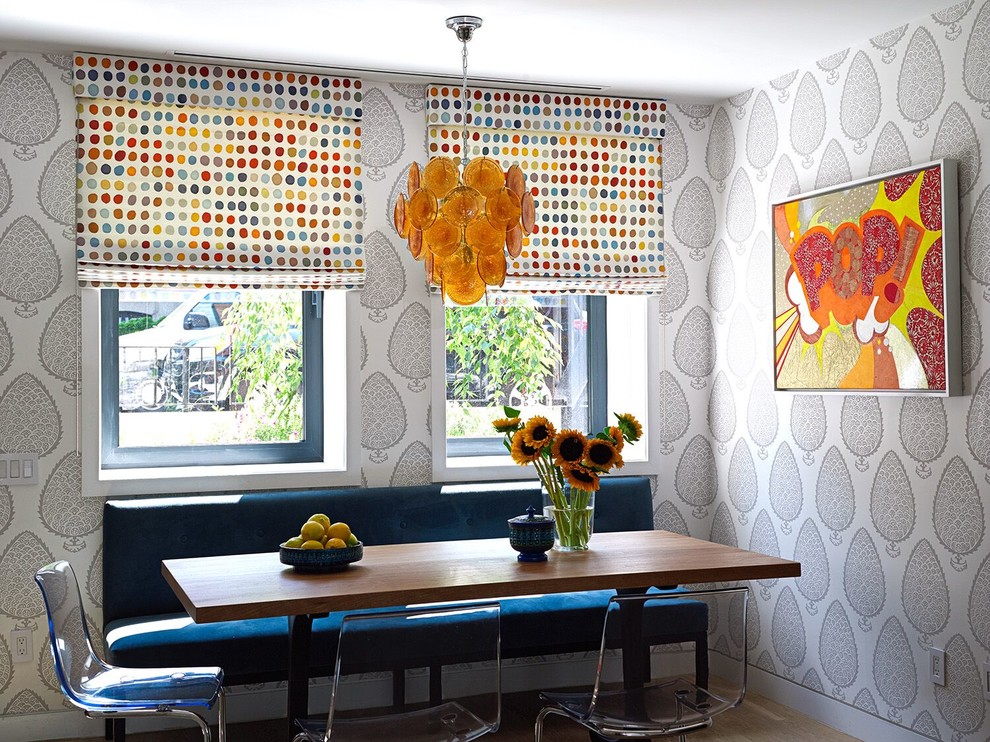 This is an example of a contemporary dining room in New York with grey walls.