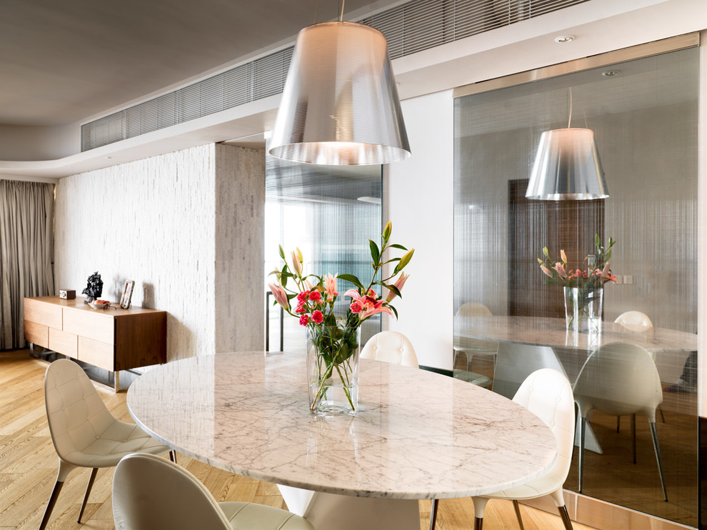 Idées déco pour une salle à manger ouverte sur le salon contemporaine avec un mur blanc, parquet clair et un sol beige.