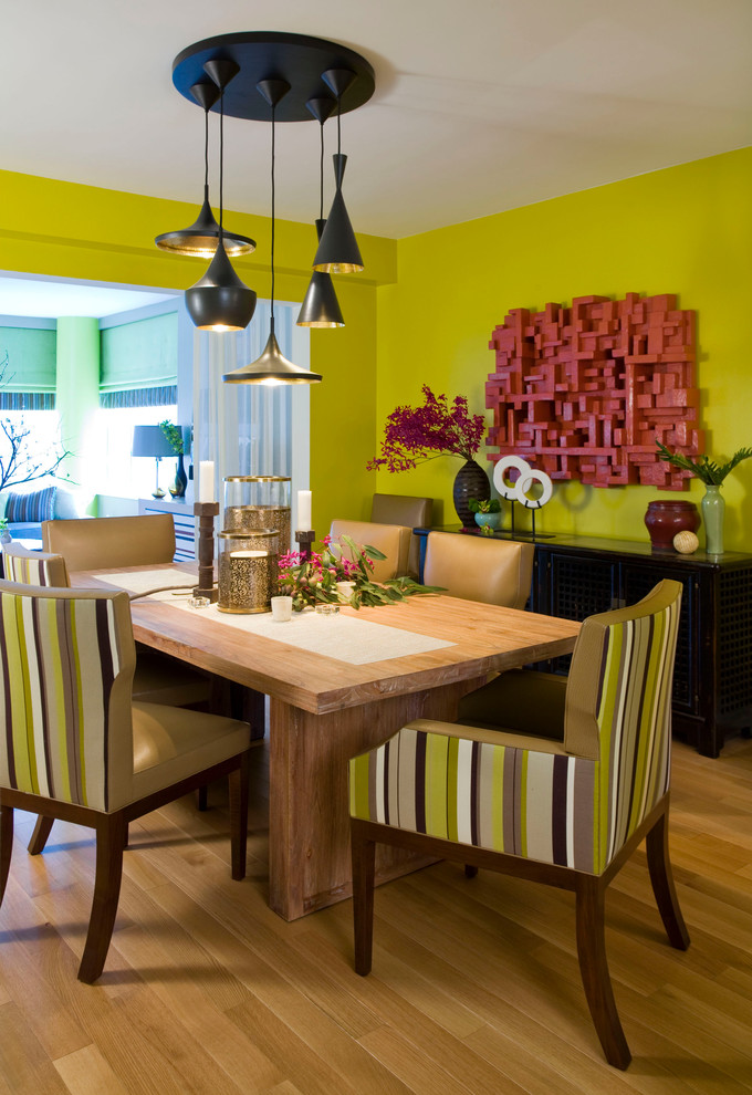 Dining room - contemporary medium tone wood floor dining room idea in New York with green walls