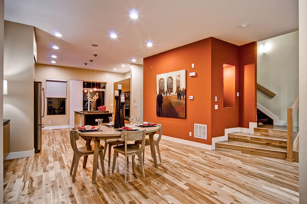 Inspiration for a contemporary medium tone wood floor kitchen/dining room combo remodel in Denver with orange walls
