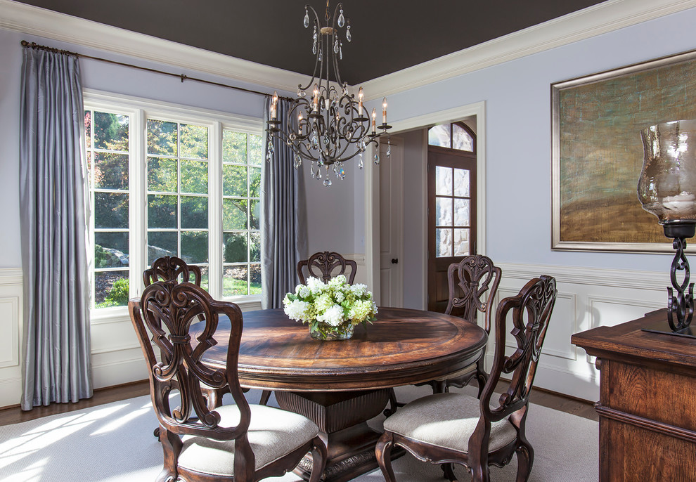 Photo of a medium sized contemporary enclosed dining room in Charlotte with blue walls and dark hardwood flooring.