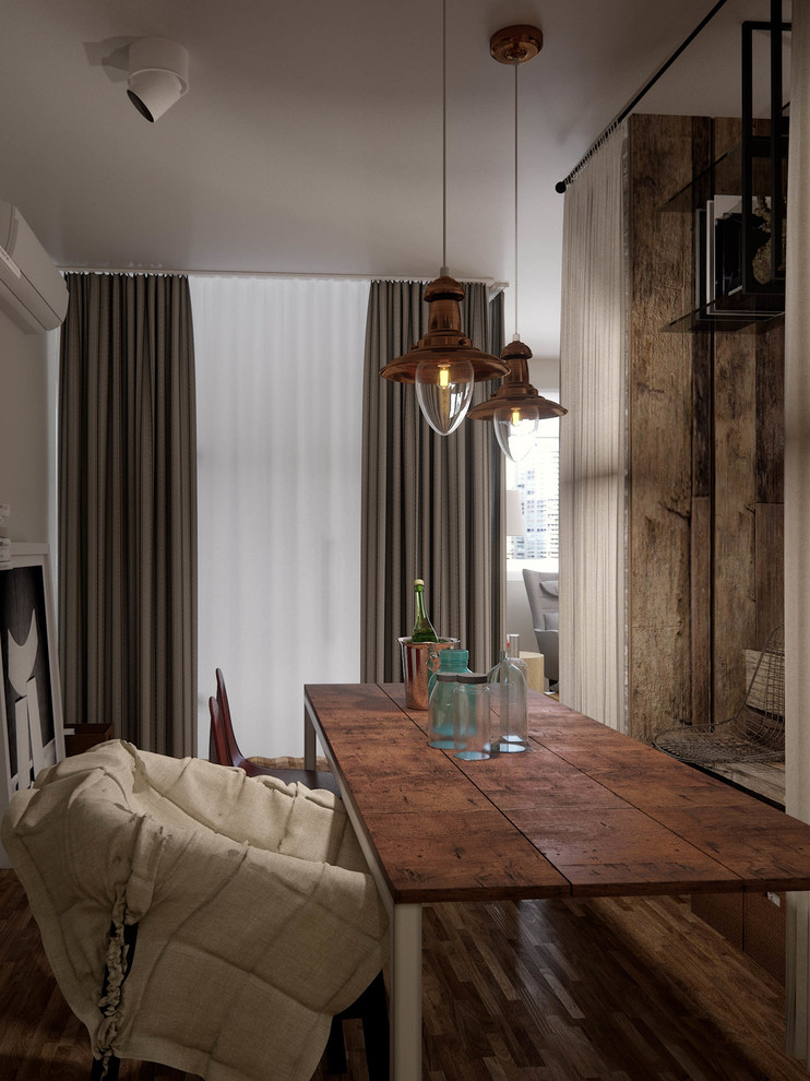Photo of a small urban open plan dining room in London with white walls and light hardwood flooring.