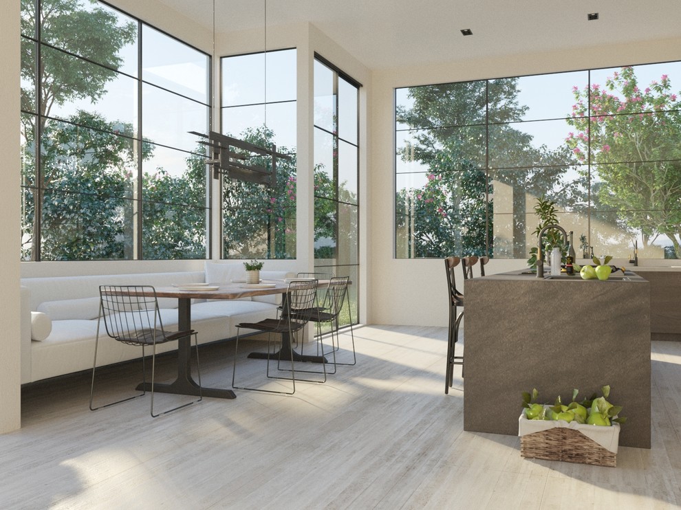 Cette photo montre une grande salle à manger ouverte sur la cuisine tendance avec un mur blanc, sol en béton ciré et un sol gris.