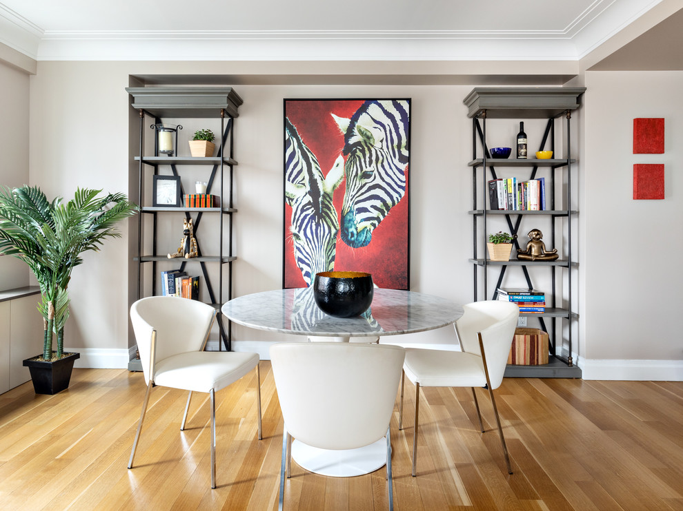 Example of a mid-sized trendy light wood floor and beige floor great room design in New York with gray walls and no fireplace