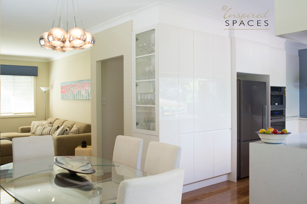 Photo of a contemporary dining room in Sydney with beige walls and medium hardwood flooring.