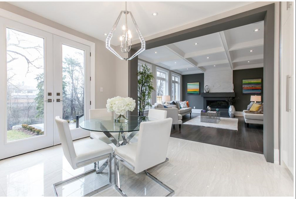 Medium sized contemporary kitchen/dining room in Toronto with ceramic flooring, white floors, beige walls, a standard fireplace and a concrete fireplace surround.