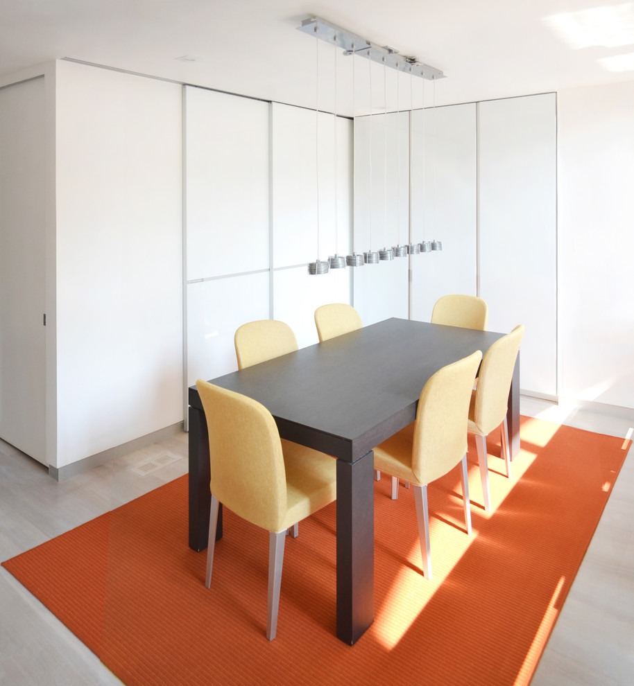 Idée de décoration pour une petite salle à manger ouverte sur la cuisine design avec un mur blanc et parquet clair.