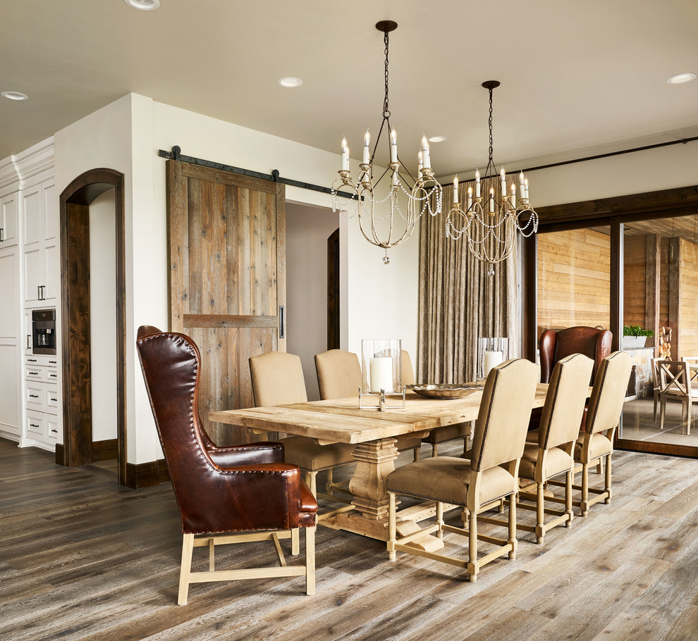 Farmhouse dining room in Portland with white walls, medium hardwood flooring, no fireplace and brown floors.