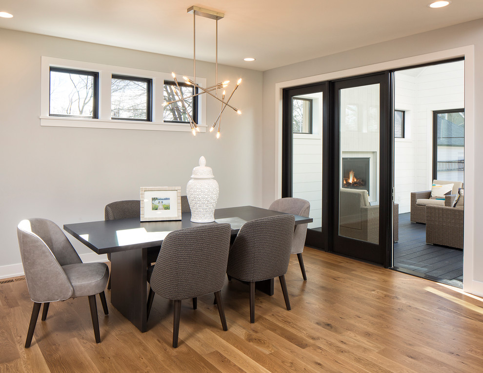 This is an example of a medium sized contemporary kitchen/dining room in Minneapolis with grey walls, light hardwood flooring and brown floors.