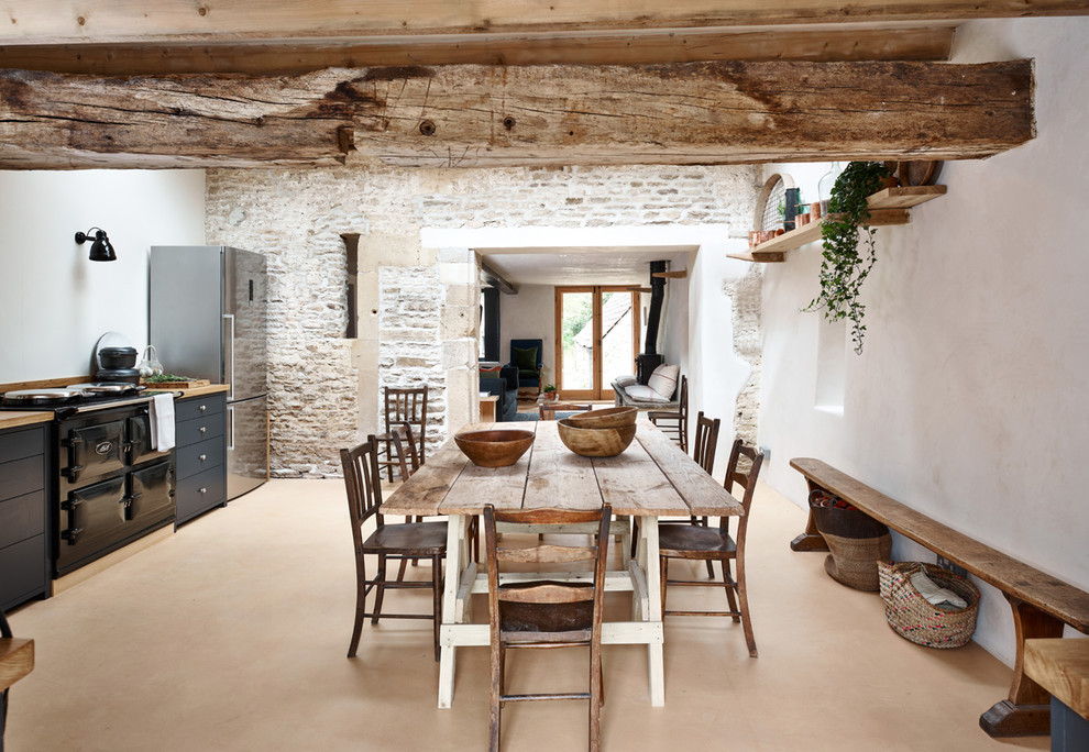 Inspiration for a medium sized farmhouse kitchen/dining room with white walls and orange floors.