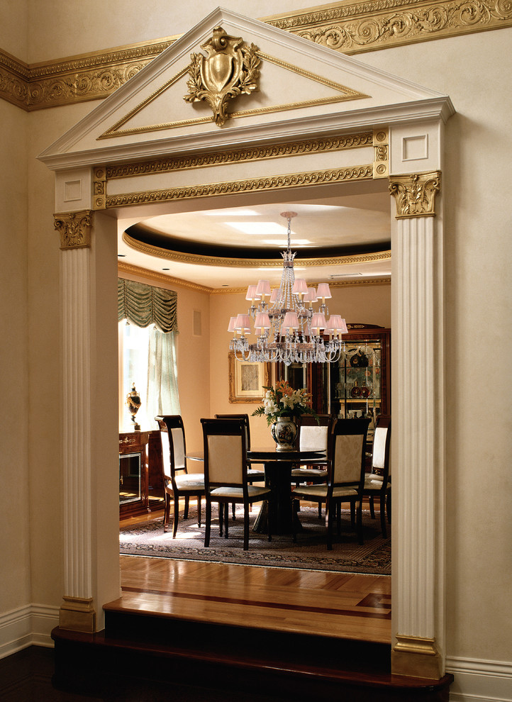 Dining room - traditional medium tone wood floor dining room idea in Miami with beige walls