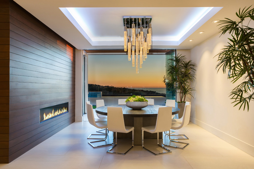 Design ideas for a large contemporary enclosed dining room in Orange County with white walls, a ribbon fireplace, a wooden fireplace surround, beige floors and concrete flooring.
