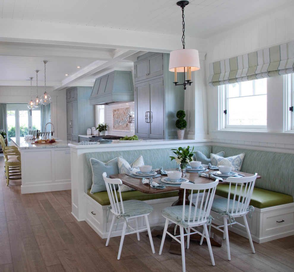 Inspiration for a coastal medium tone wood floor kitchen/dining room combo remodel in San Diego with white walls