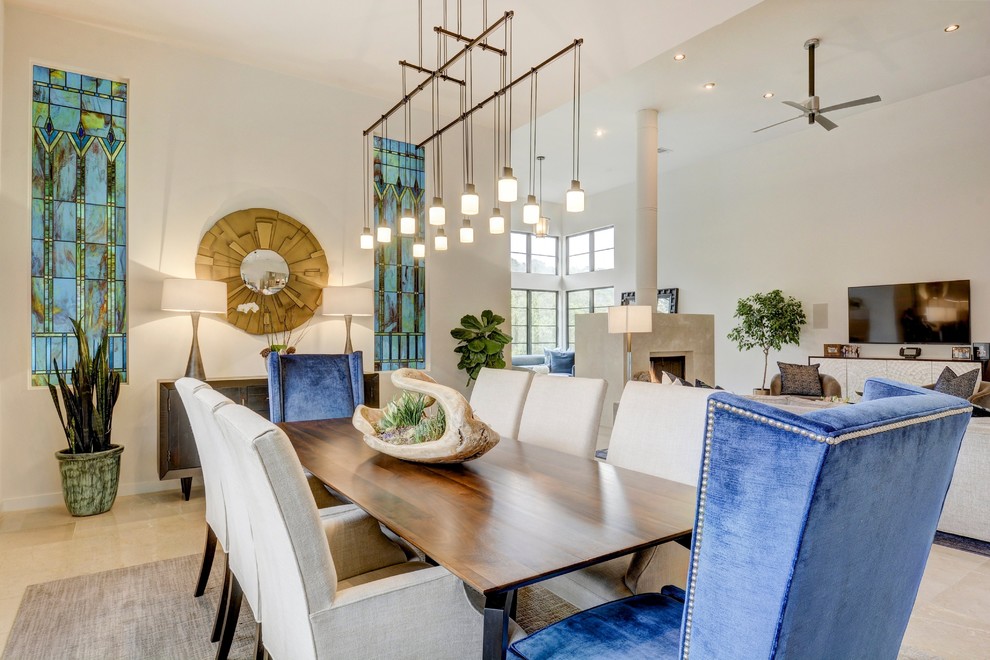 Photo of a contemporary dining room in Austin with white walls and beige floors.