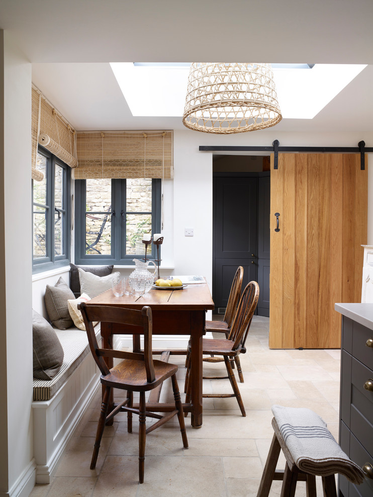 This is an example of a small farmhouse kitchen/dining room in Oxfordshire with white walls.