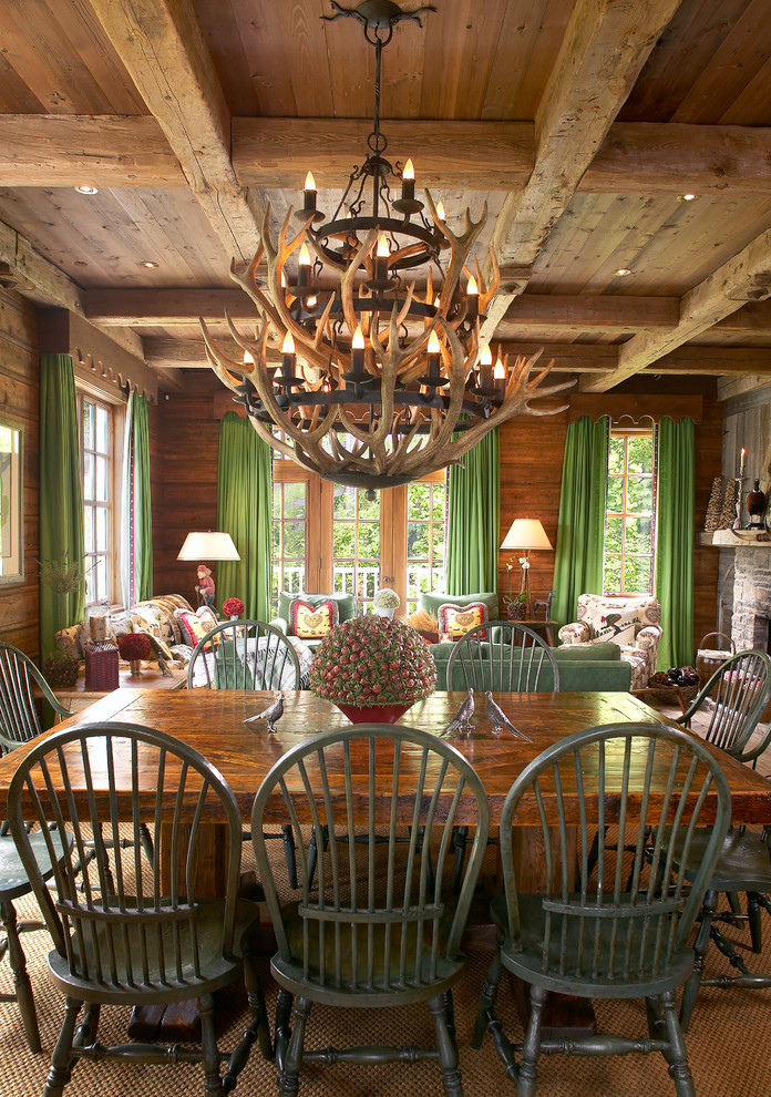 This is an example of a rustic open plan dining room in Montreal with feature lighting.