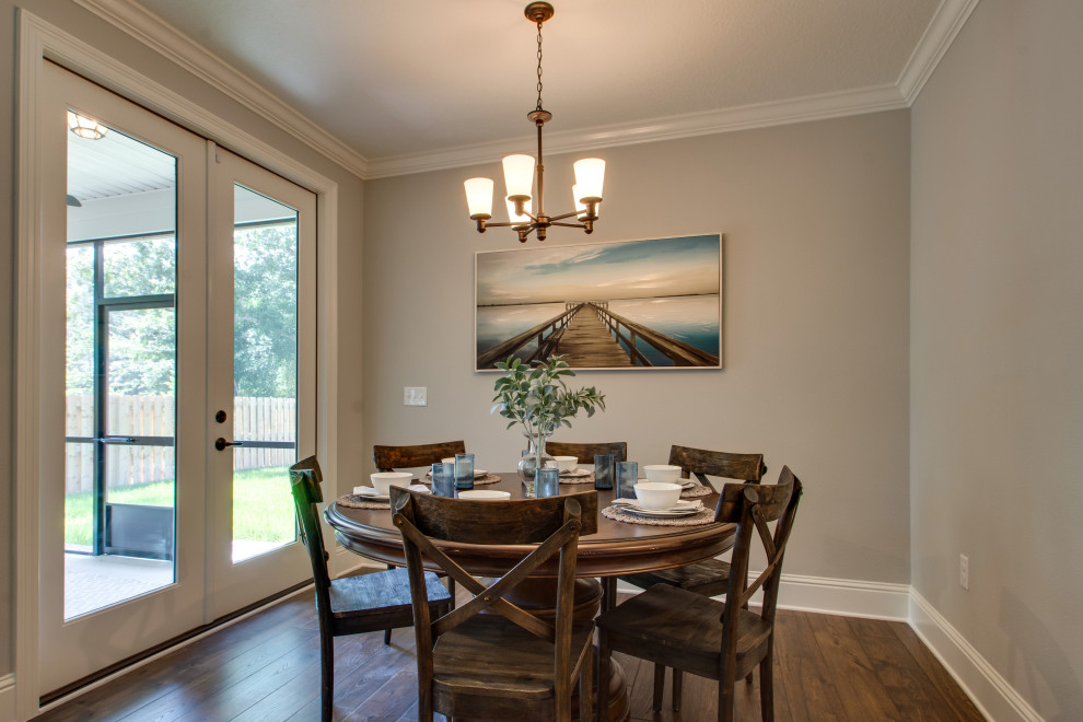 Photo of a traditional dining room in Other with banquette seating, grey walls, medium hardwood flooring and brown floors.