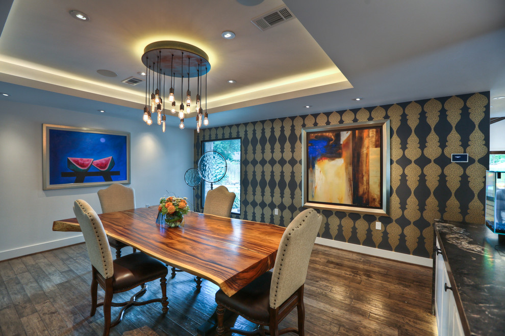 Photo of a contemporary dining room in Houston with multi-coloured walls and dark hardwood flooring.