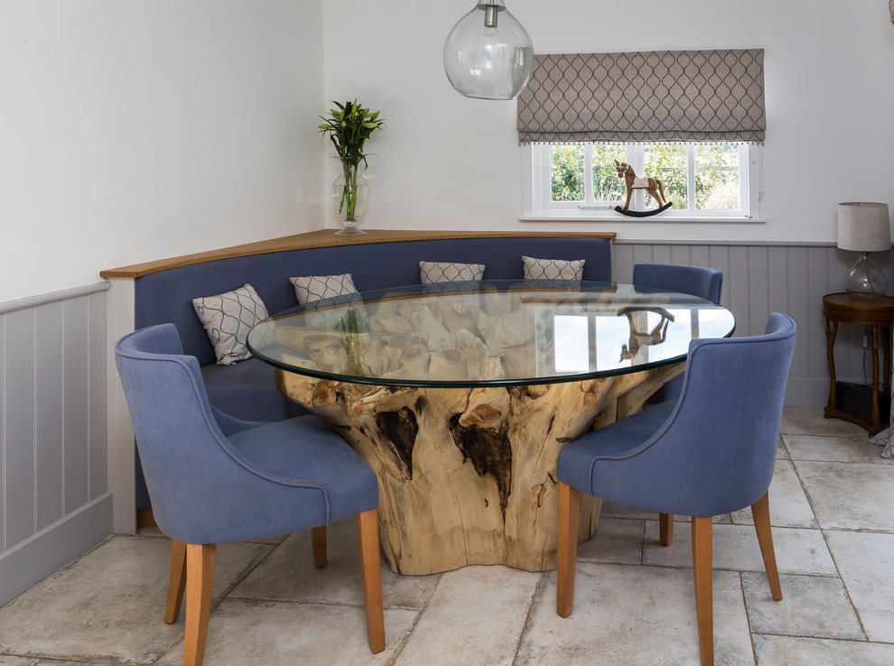 This is an example of a farmhouse dining room in Hertfordshire with white walls and grey floors.