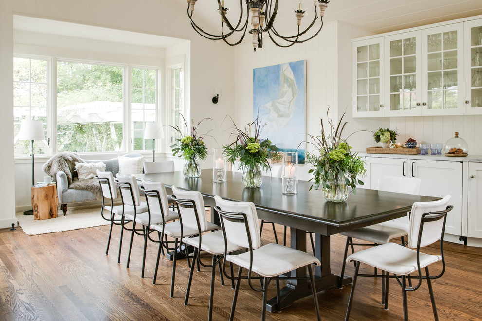 Large rural enclosed dining room in San Francisco with dark hardwood flooring, white walls, no fireplace, brown floors and feature lighting.