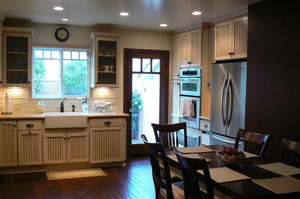 На фото: кухня-столовая среднего размера в классическом стиле с темным паркетным полом, коричневыми стенами и коричневым полом