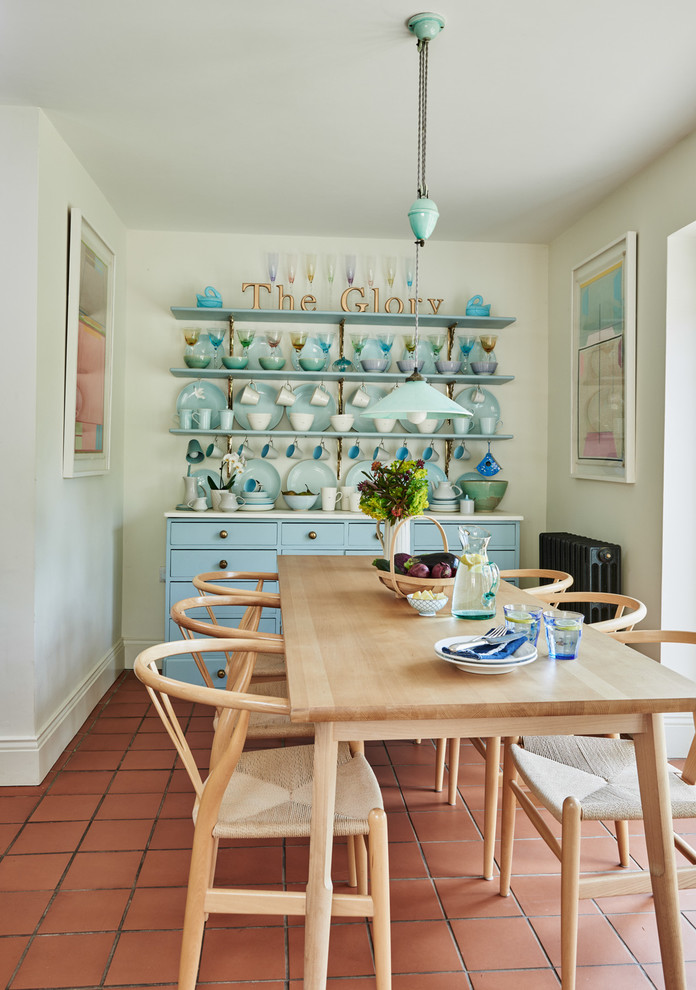 Photo of a medium sized rural kitchen/dining room in Other with white walls and terracotta flooring.