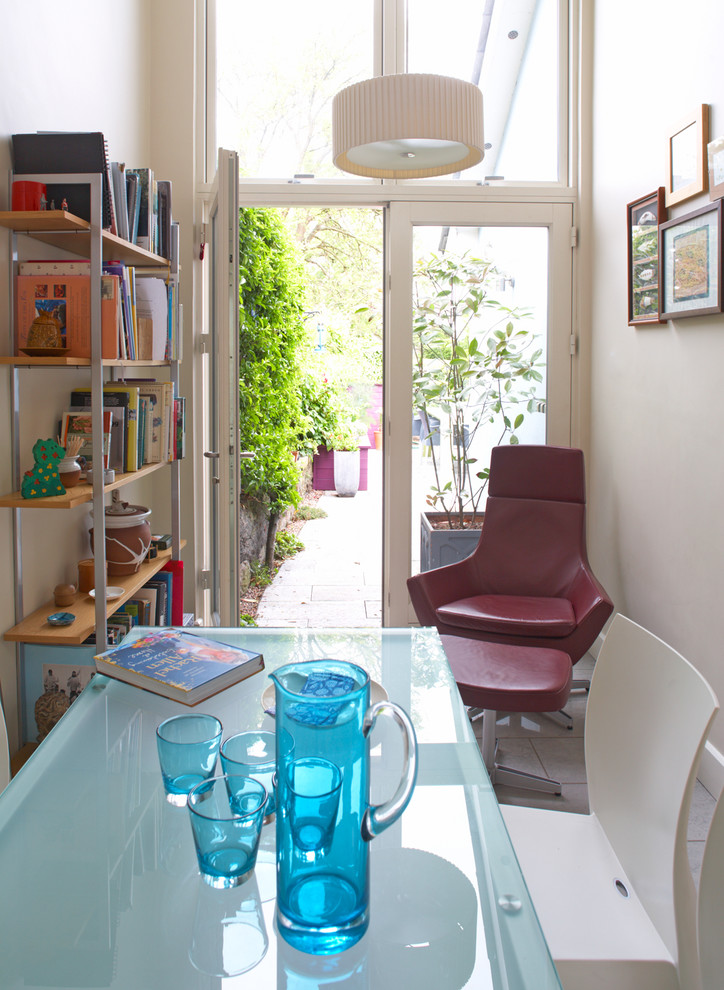 Example of a small trendy dining room design in Dublin with white walls