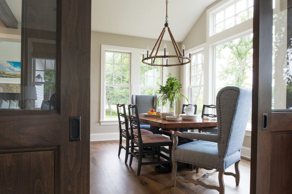 Photo of a medium sized traditional enclosed dining room in Minneapolis with beige walls, medium hardwood flooring, no fireplace and brown floors.