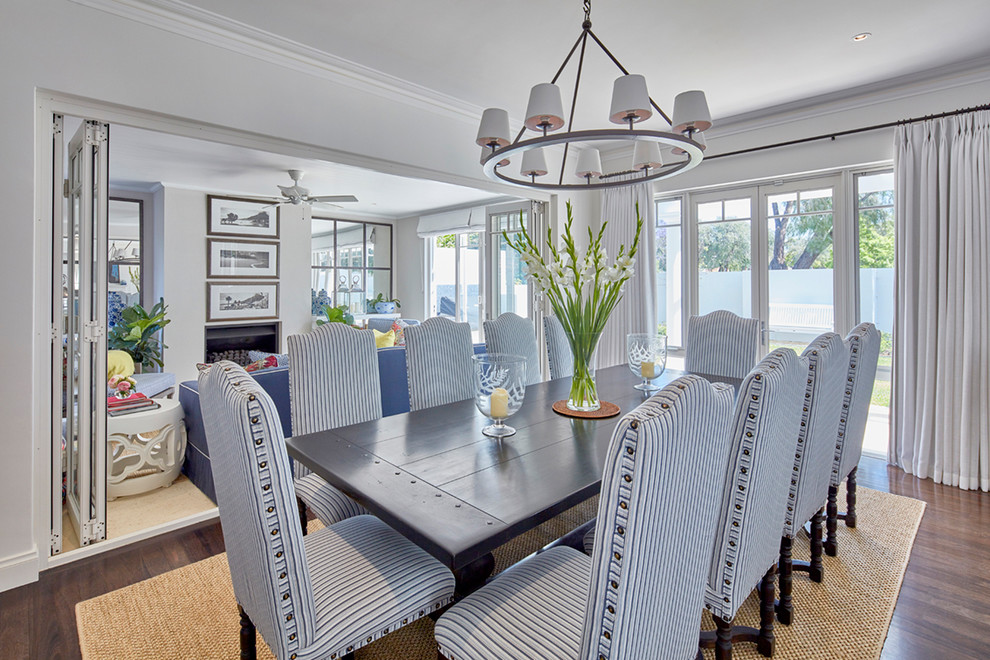 This is an example of a medium sized nautical enclosed dining room in Perth with white walls, dark hardwood flooring and brown floors.