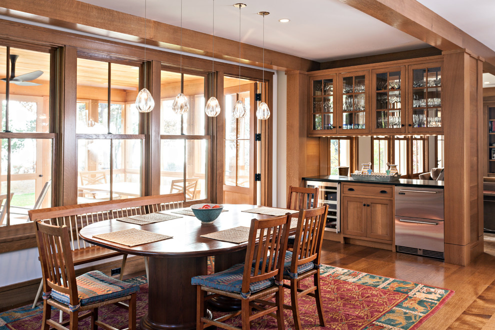 Classic kitchen/dining room in Boston with white walls and dark hardwood flooring.