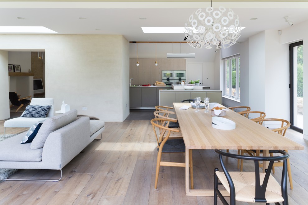Стильный дизайн: гостиная-столовая в современном стиле с бежевыми стенами и паркетным полом среднего тона - последний тренд