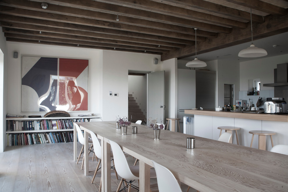 Ispirazione per una sala da pranzo aperta verso la cucina country con pareti bianche e parquet chiaro