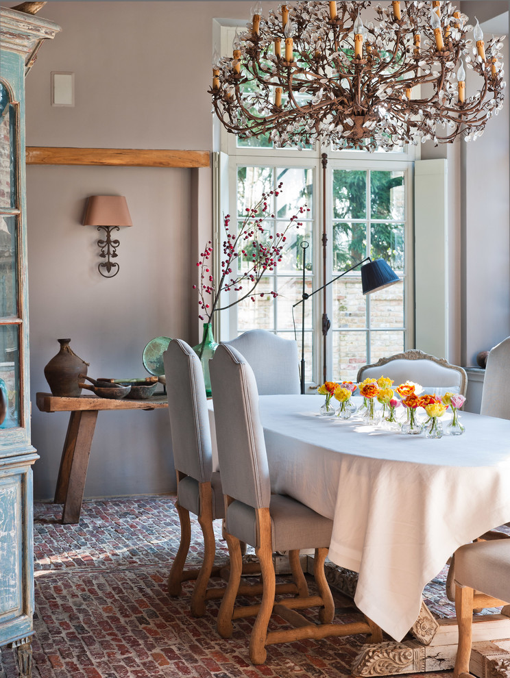 Elegant brick floor enclosed dining room photo in Other with gray walls