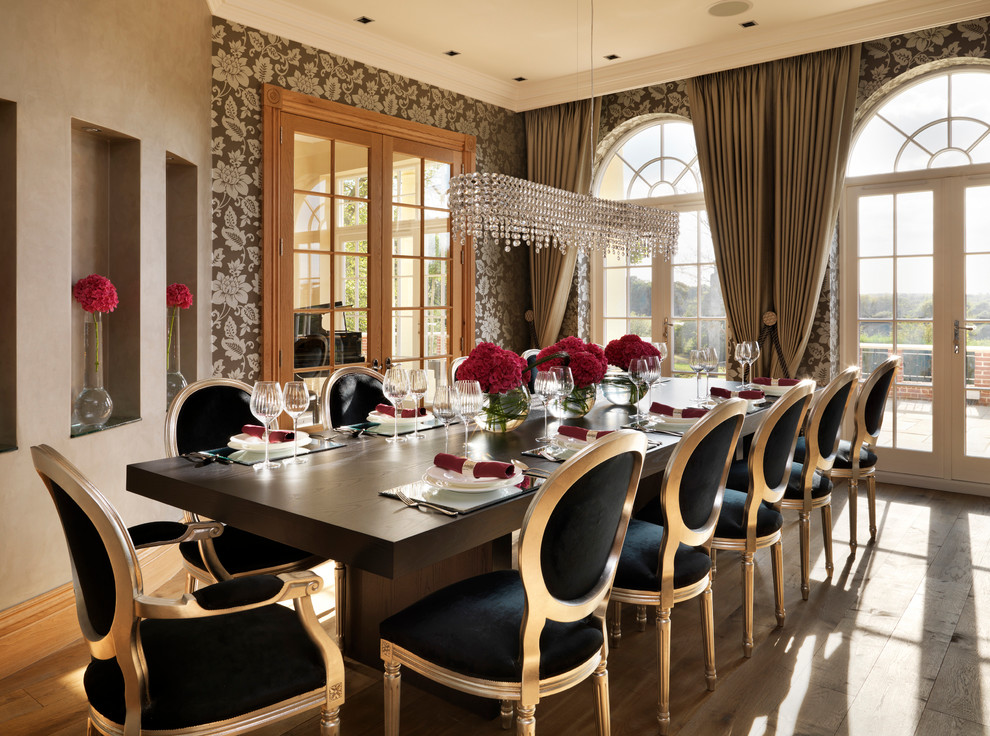 Example of a huge classic medium tone wood floor enclosed dining room design in London with no fireplace and brown walls