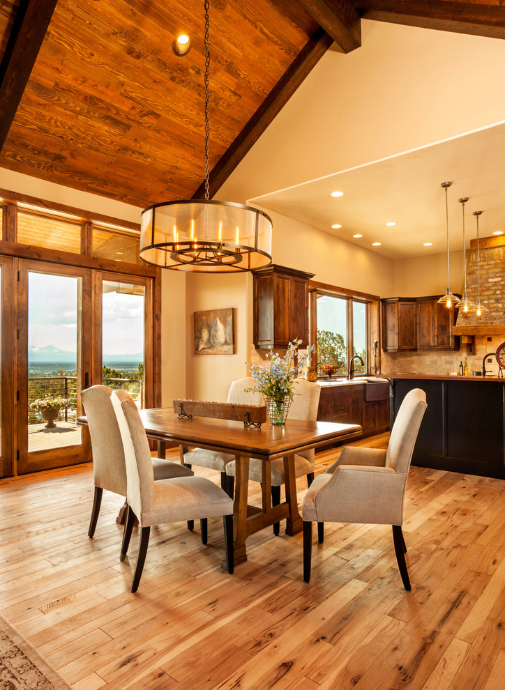This is an example of a medium sized rustic kitchen/dining room in Other with beige walls, light hardwood flooring, no fireplace and brown floors.