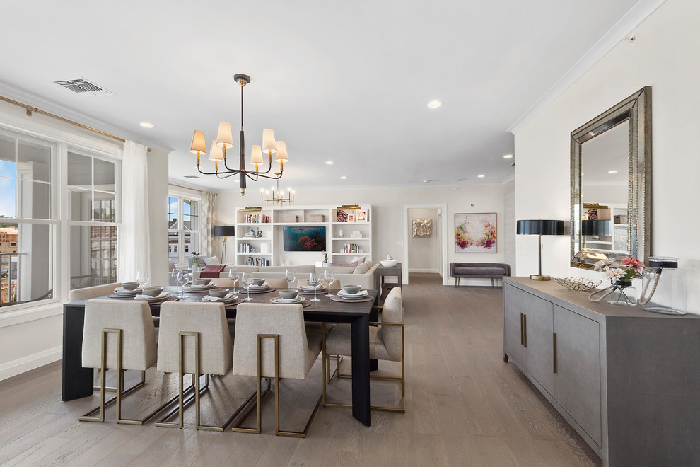 Classic open plan dining room in New York with beige walls, medium hardwood flooring, brown floors and feature lighting.