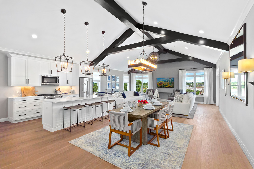 This is an example of a traditional open plan dining room in New York with grey walls, medium hardwood flooring and brown floors.